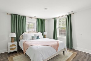 Bedroom with queen bed, contemporary vibe, and room darkening shades