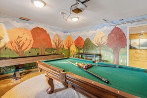 Game room with pool table and shuffleboard for endless fun.