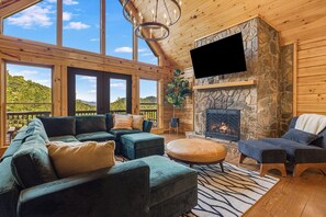  Cozy living room with stunning mountain views and a fireplace. 