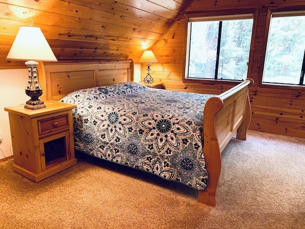 King bed in the third floor ‘treehouse like’ master suite with pretty forest views. 