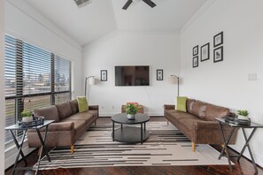 Living room with City skyline views!  50 Inch Roku TV and seating for 6.