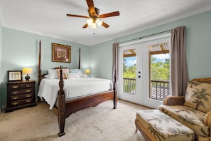 The second guest bedroom indulges guests with a Queen bed and a private balcony overlooking the portico with a water view.