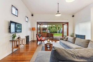 Living room with flat screen TV. This rooms opens up to the patio making it perfect for entertaining.