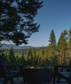 Fire pit with mountain and meadow views