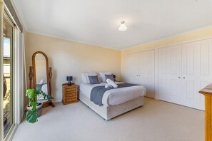 Bedroom one - main bedroom with balcony, queen size bed, TV, ample storage and direct access to th shared bathroom.