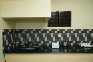 Kitchen counter with stove, toaster, kettle 