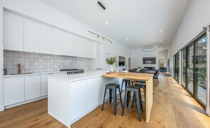 Fully equipped kitchen with breakfast bar, modern appliances and large bench space.