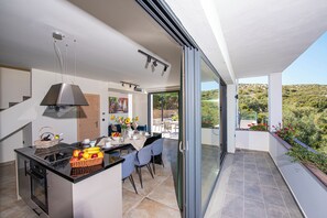 Main villa open plan fully equipped kitchen - dining - living area