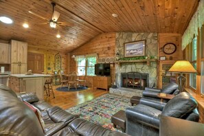 Relax in an inviting living space with plush seating and a widescreen TV, designed for your relaxation and enjoyment.