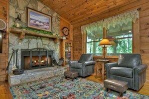 Relax in an inviting living space with plush seating and a widescreen TV, designed for your relaxation and enjoyment.