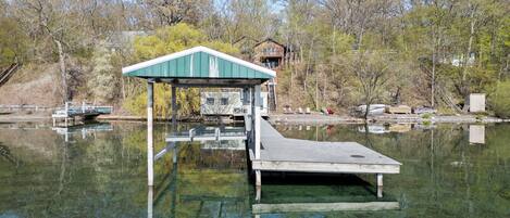 Lakefront / Boathouse / Dock (requires three flights of stairs to access) - Experience serene lakeside living with our private dock and boathouse, perfect for relaxation and water activities. Ideal for those seeking a peaceful waterfront getaway. 