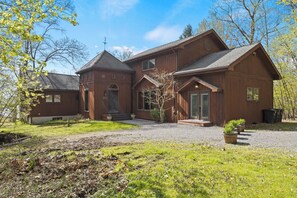 Escape to this charming lakeside retreat on Seneca Lake, featuring a rustic wooden entryway that promises a serene getaway amidst lush surroundings. Perfect for relaxation and local exploration. 
