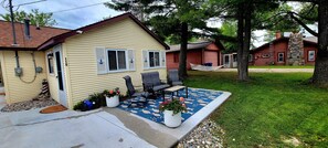 Relax on the front patio with lake view. Rocking chairs and a glider bench.