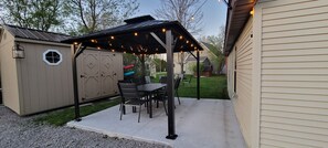 Enjoy dinner out on the back patio,  sitting  for 6 w/ string lights to set mood