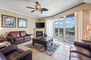 Living Area - The spacious living area features comfortable, leather furniture and balcony access.