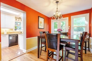 Enjoy vibrant meals in this bright space with a charming chandelier and garden views!