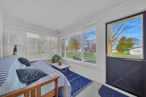 Three season room to sip your morning coffee on with additional sleep arrangements too!