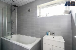 Relax and unwind in the soothing bathtub, perfect for a peaceful soak.