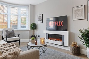Enter this living room and relax with the ambience of soft lighting and complete comfort,  log In and connect to your Netflix or Prime account on the 50 inch TV and relax on this Sofa which also pulls out to accommodate 2 guests for that added space.