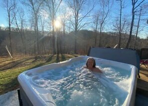 Hottub surrounded by forest. $50 one-time set-up fee. Pretty lady not included. 
