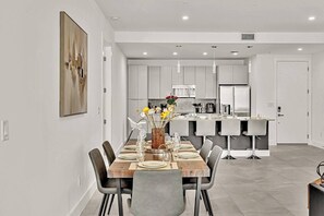 Spacious dining room with ample seating and storage for entertaining.