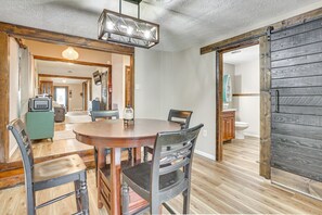 Gather 'round this cozy wooden dining table for a delicious meal with good company!