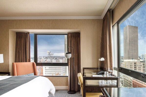An elegant room featuring a plush king bed, complete with a cozy seating area and warm, inviting decor.