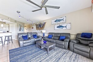 A large smart TV awaits for cozy movie nights, while sliders open up to the private balcony, inviting in the soothing sea breeze.