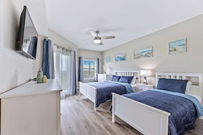 In the main bedroom, immerse yourself in undersea serenity with a queen-size bed and a twin.
