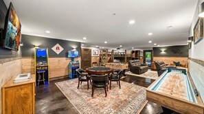 This lower level game room is the ultimate entertainment hub, located in the Home Theater/Bunk Room