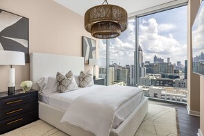 Secondary suite with a queen bed and a 55" 4K UHD TV
