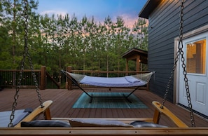 Whether you're curled up with a good book in the hammock or gently rocking in the swing chair, our outdoor sanctuary is your ticket to tranquility.