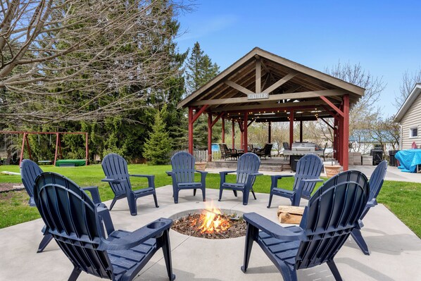 Large fire pit with 8 adirondack chairs.