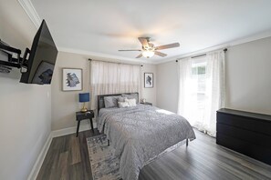 Bedroom 1- features a Queen bed, smart TV and a ceiling fan.
