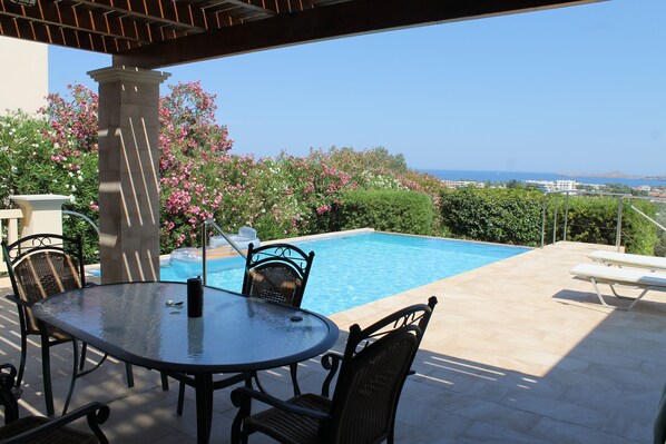 Outdoor pool terrace with view of the sea