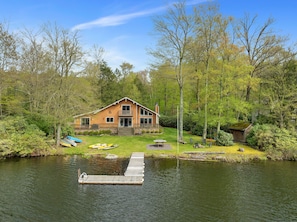 View of the Secluded Lakefront Escape from the lake. Big deck, lots of loungers in the yard.
