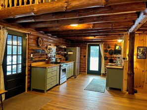 Main entrance on left, full kitchen and side entrance toward pond.