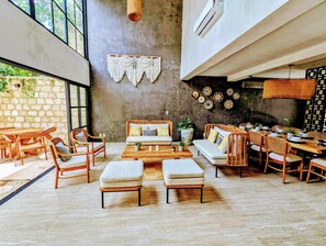 The Tulum days: swimming in the pool, soThe Villa features an open design, high ceilings, big windows, nature-chic decor in the inviting living space