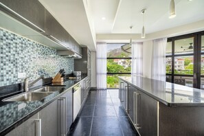 Enjoy natural light through floor to ceiling windows while catching glimpse of enchanting views from our kitchen space.