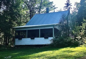 Big screened-in porch overlooks the lake so you can see when the loons are about
