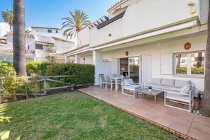 Garden area with comfortable furniture to relax or enjoy a nice meal outdoors enjoying green lawn. (2)