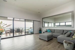 Enjoy beach views from the spacious living room with a scenic balcony.