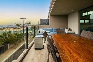 Relax with loved ones on a cozy deck sofa, surrounded by the serene beauty of the beach, offering the perfect setting for unforgettable family moments.