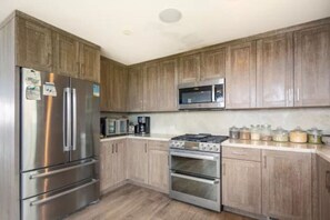 The kitchen is fully equipped with top-of-the-line appliances, ready for you to whip up delicious meals during your stay.