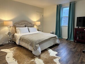 Our cozy master bedroom on the 2nd floor has a Queen bed, TV, closet, and desk