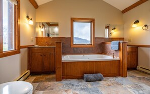 Main level bathroom with tub, double vanities and step in shower