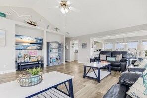 Another angle of the living room, offering a glimpse of the kitchen.