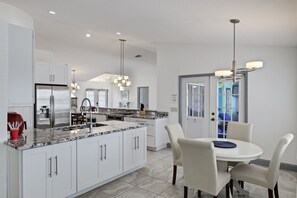 Fully equipped kitchen with dining table capable of seating four guests
