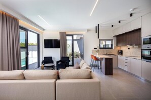 Open plan living and kitchen area with direct outdoor access