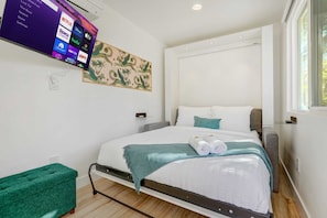 Unwind in comfort with a luxurious queen-sized Murphy bed and a 4K Roku Smart TV – the perfect space to relax after a day of adventure.